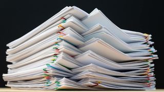 Stack of papers separated with paperclips.