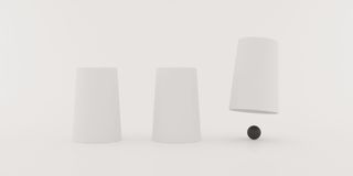 Three upside cups with one lifted revealing a small sphere.