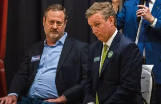 Two white men with odd looks on their face.
