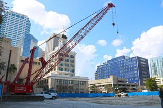 A crane with Tampa City Hall and the Police HQ in background.