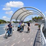Facing a small group of people riding bicycles on the Riverwalk.