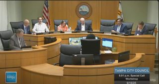 Tampa City Council sitting at dais with council attorney seated below and to left.