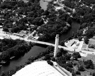 Black and white arial photo of the Sulphur Springs water tower along the Hillsborough River viewed from the east towards Florida Ave.